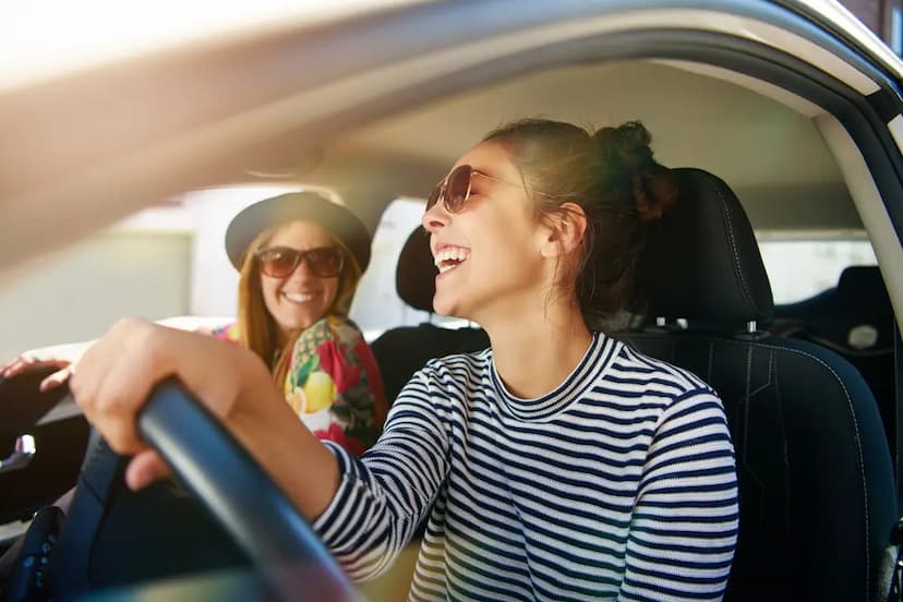 Two woman driving in a car with extended car warranty